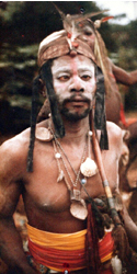 Bwiti medicine man in ceremonial headdress and beads